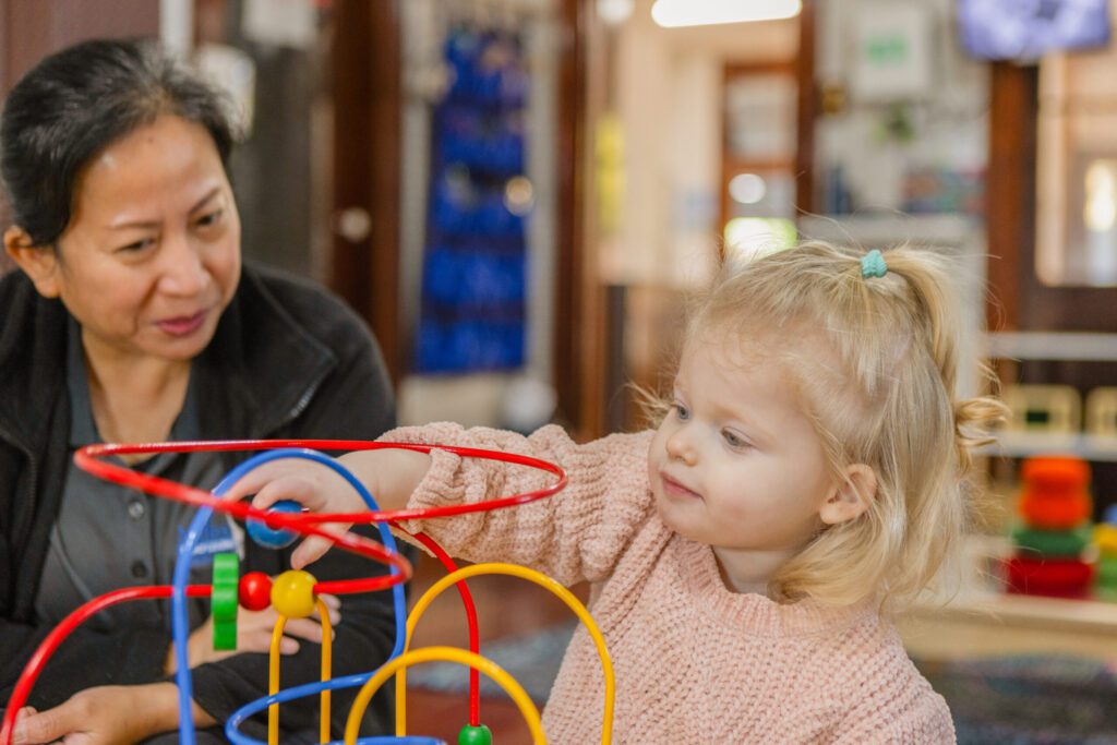 Educators guiding children in sensory activities designed to boost brain development.