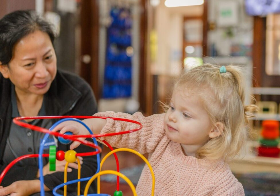 Educators guiding children in sensory activities designed to boost brain development.